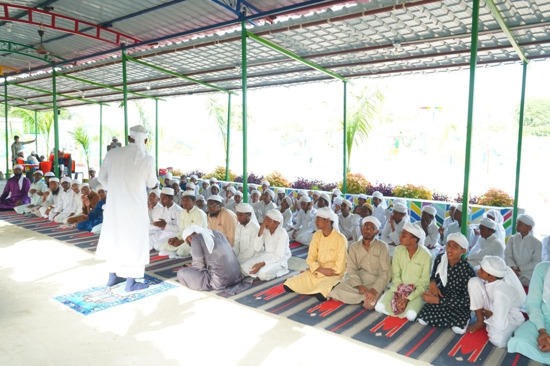 Senior teacher addressing staff and students